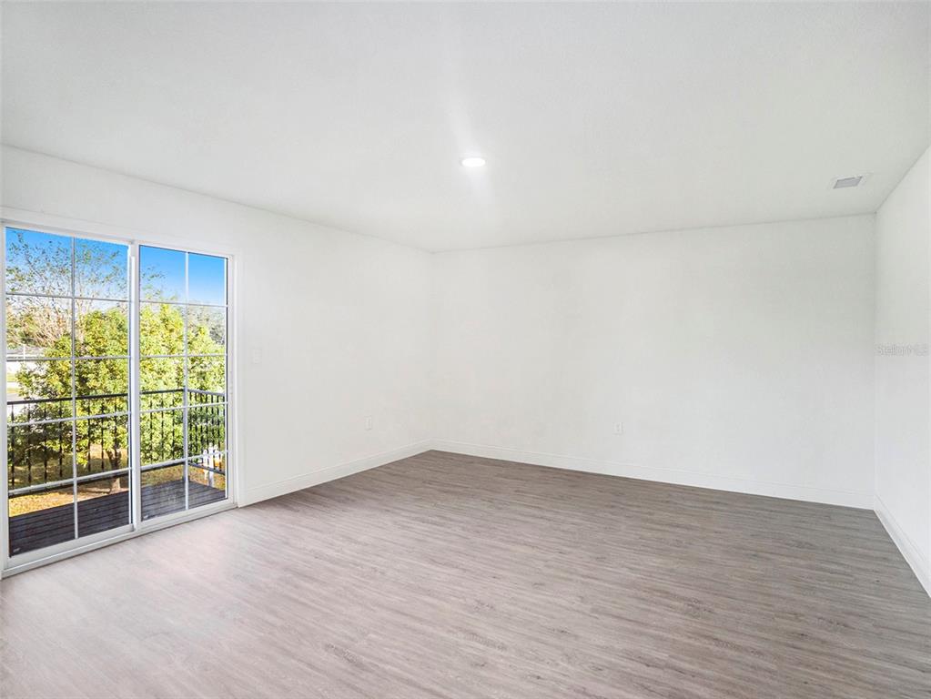 5136 Colbert Road Lakeland, FL 33812 - Photo 17 of 28 a view of an empty room with wooden floor and a window