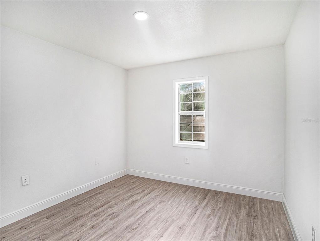 5136 Colbert Road Lakeland, FL 33812 - Photo 19 of 28 wooden floor in an empty room with a window
