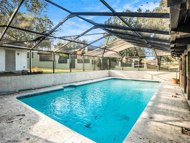 a view of a swimming pool with a patio