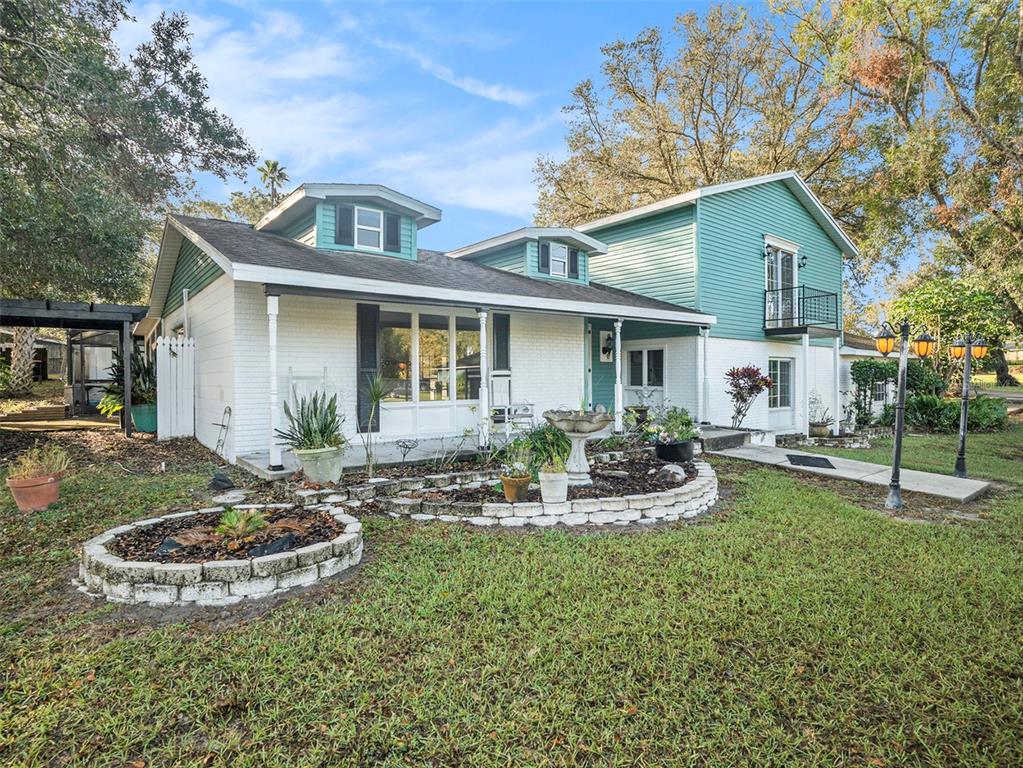 5136 Colbert Road Lakeland, FL 33812 - Photo 4 of 28 a front view of a house with garden
