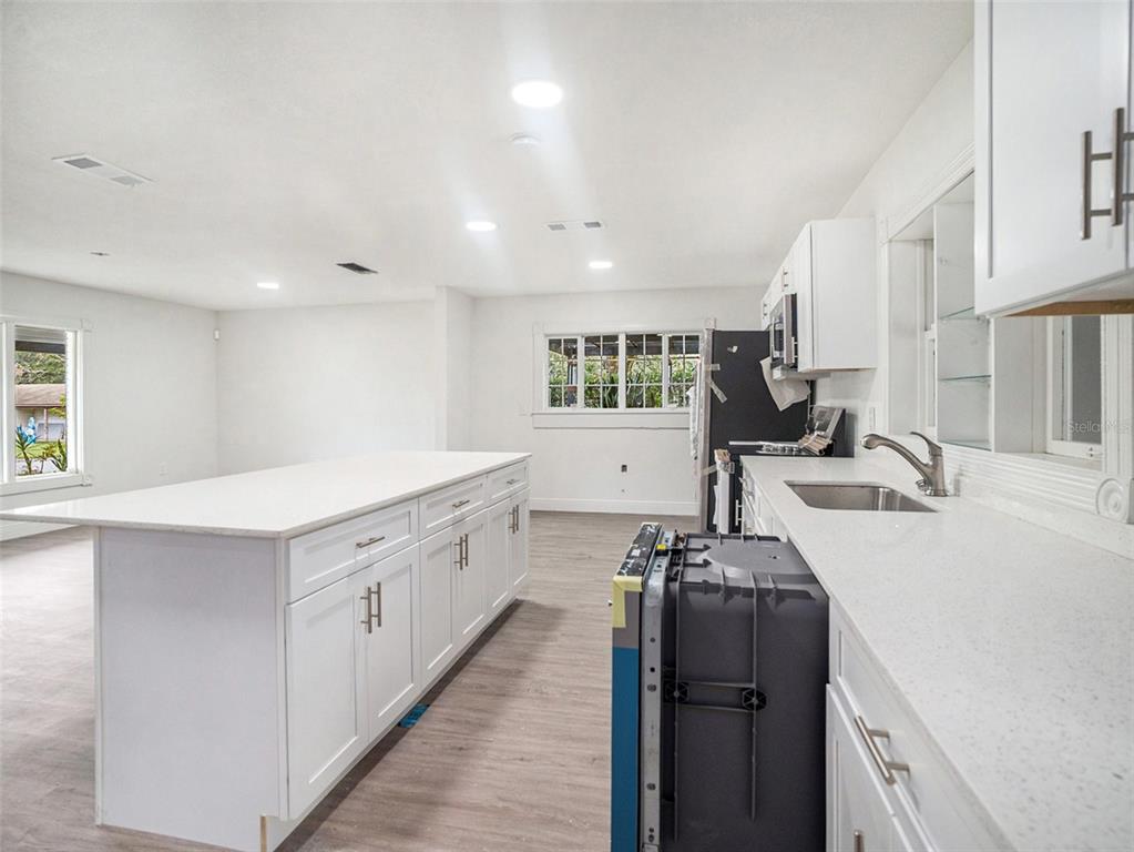 5136 Colbert Road Lakeland, FL 33812 - Photo 7 of 28 a kitchen with granite countertop a sink stove and cabinets