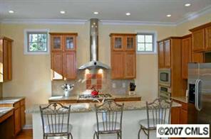 4252 Castleton Road Charlotte, NC 28211 - Photo 2 of 8 a kitchen with stainless steel appliances granite countertop a refrigerator and a stove