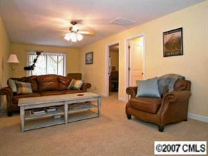 4252 Castleton Road Charlotte, NC 28211 - Photo 6 of 8 a living room with furniture and a chandelier