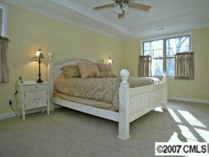 4252 Castleton Road Charlotte, NC 28211 - Photo 7 of 8 a bedroom with a bed and large windows