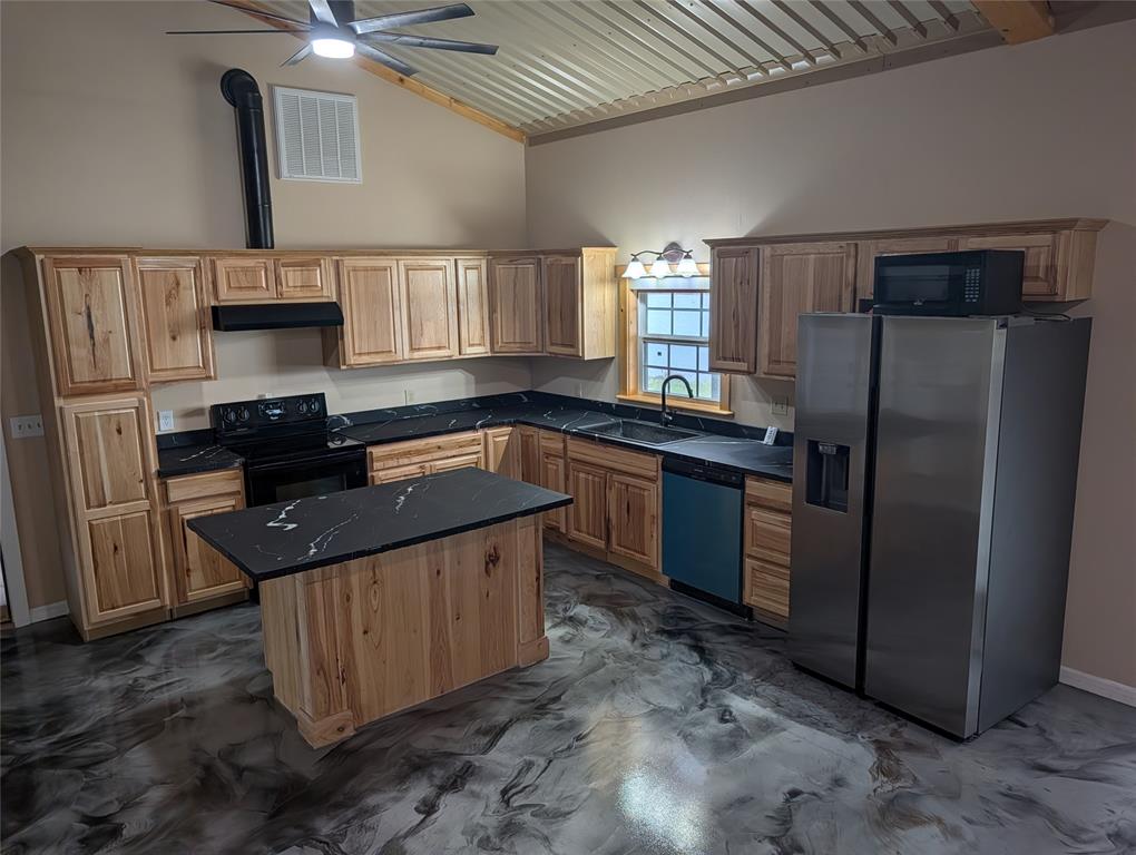 613 North Access Road Merkel, TX 79536 - Photo 8 of 11 a kitchen with stainless steel appliances granite countertop a sink stove and refrigerator