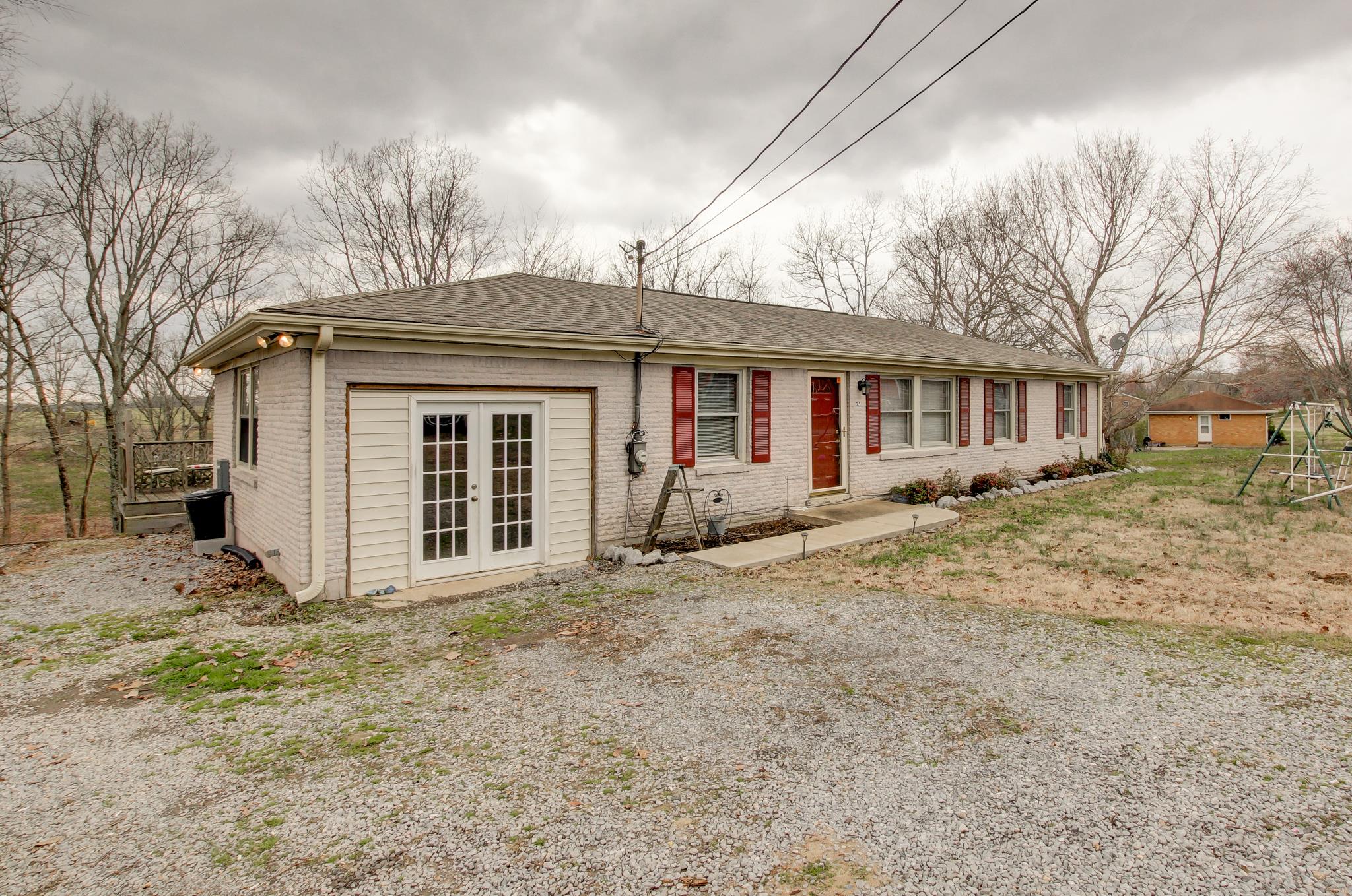 35 Locust Road Erin, TN 37061 - Photo 1 of 20 a front view of a house with a yard covered in snow