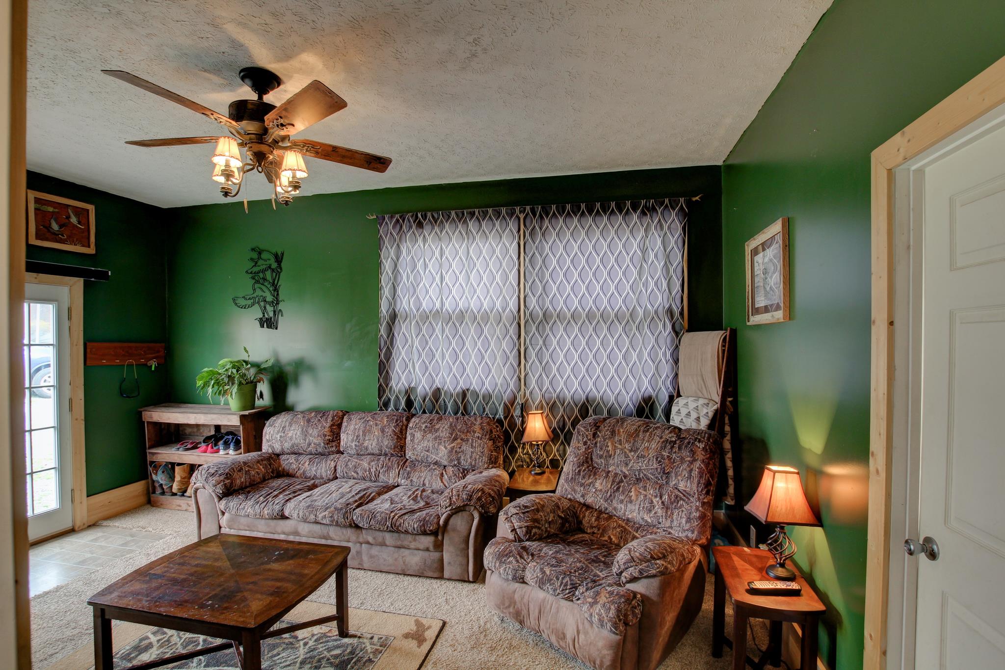 35 Locust Road Erin, TN 37061 - Photo 12 of 20 a living room with furniture and a window