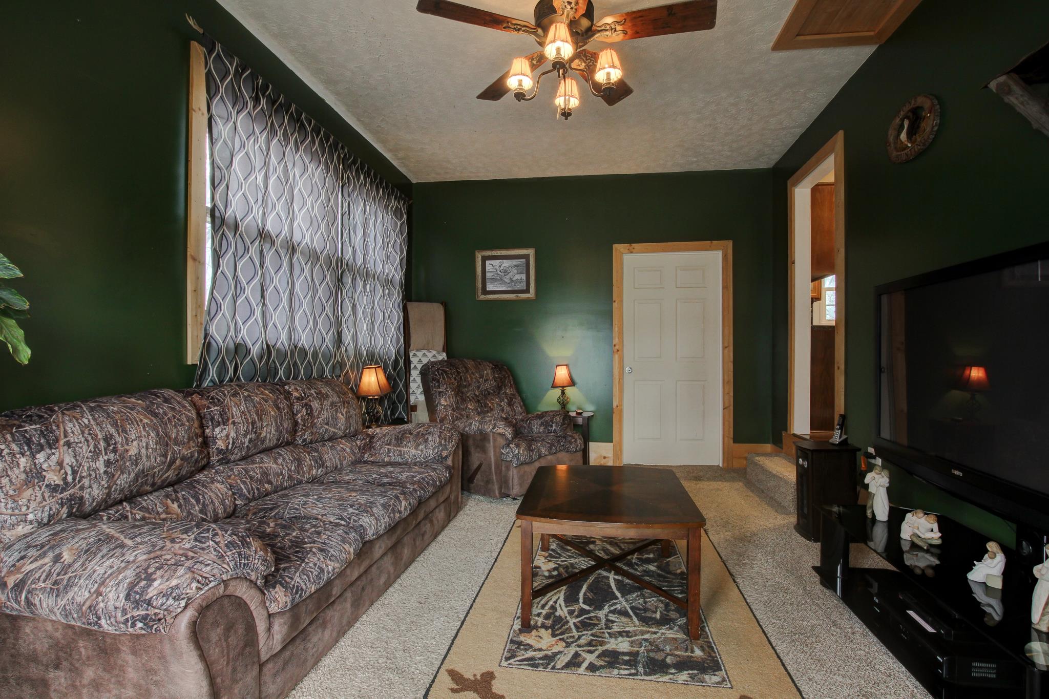 35 Locust Road Erin, TN 37061 - Photo 13 of 20 a living room with furniture and a fireplace