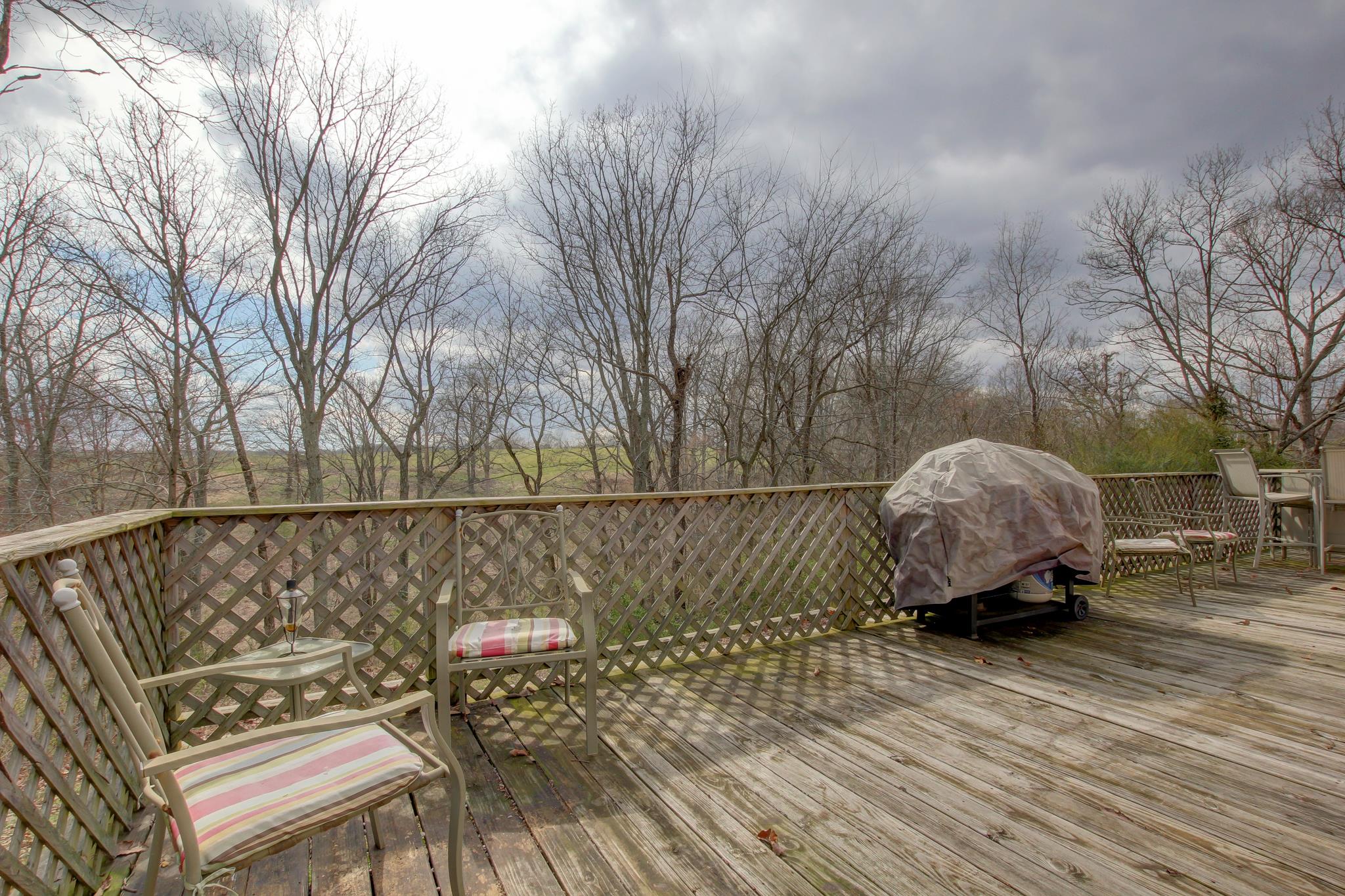 35 Locust Road Erin, TN 37061 - Photo 16 of 20 a roof deck with table and chairs and wooden floor