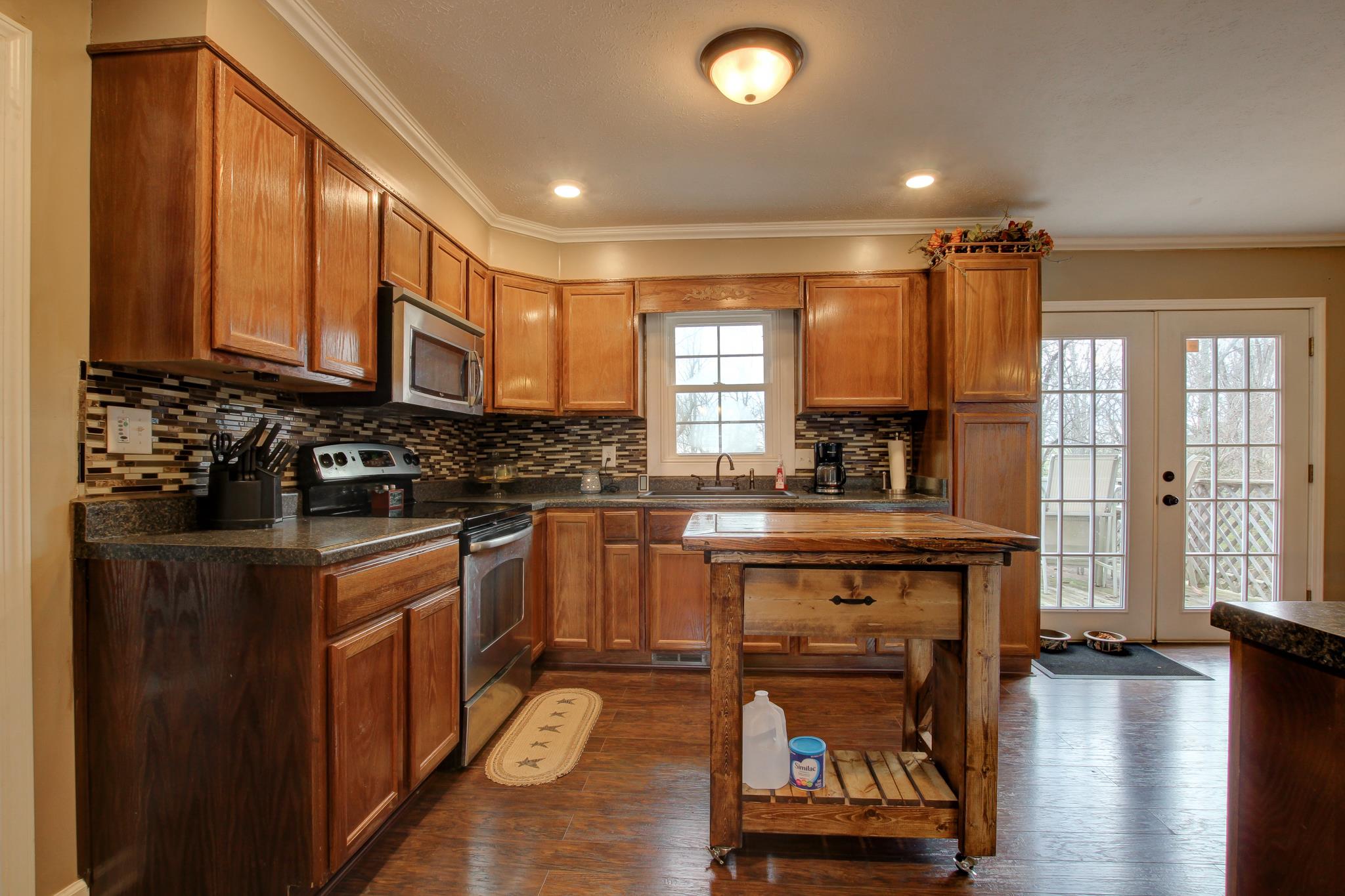 35 Locust Road Erin, TN 37061 - Photo 4 of 20 a kitchen with stainless steel appliances granite countertop a stove a sink and a refrigerator