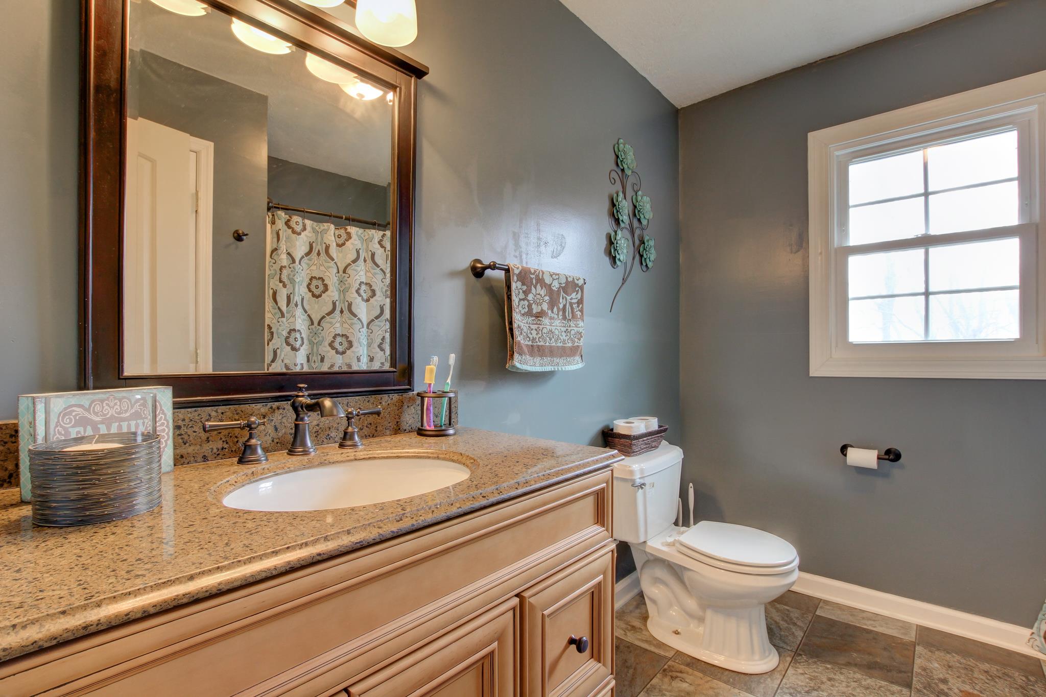 35 Locust Road Erin, TN 37061 - Photo 8 of 20 a bathroom with a granite countertop sink toilet and mirror