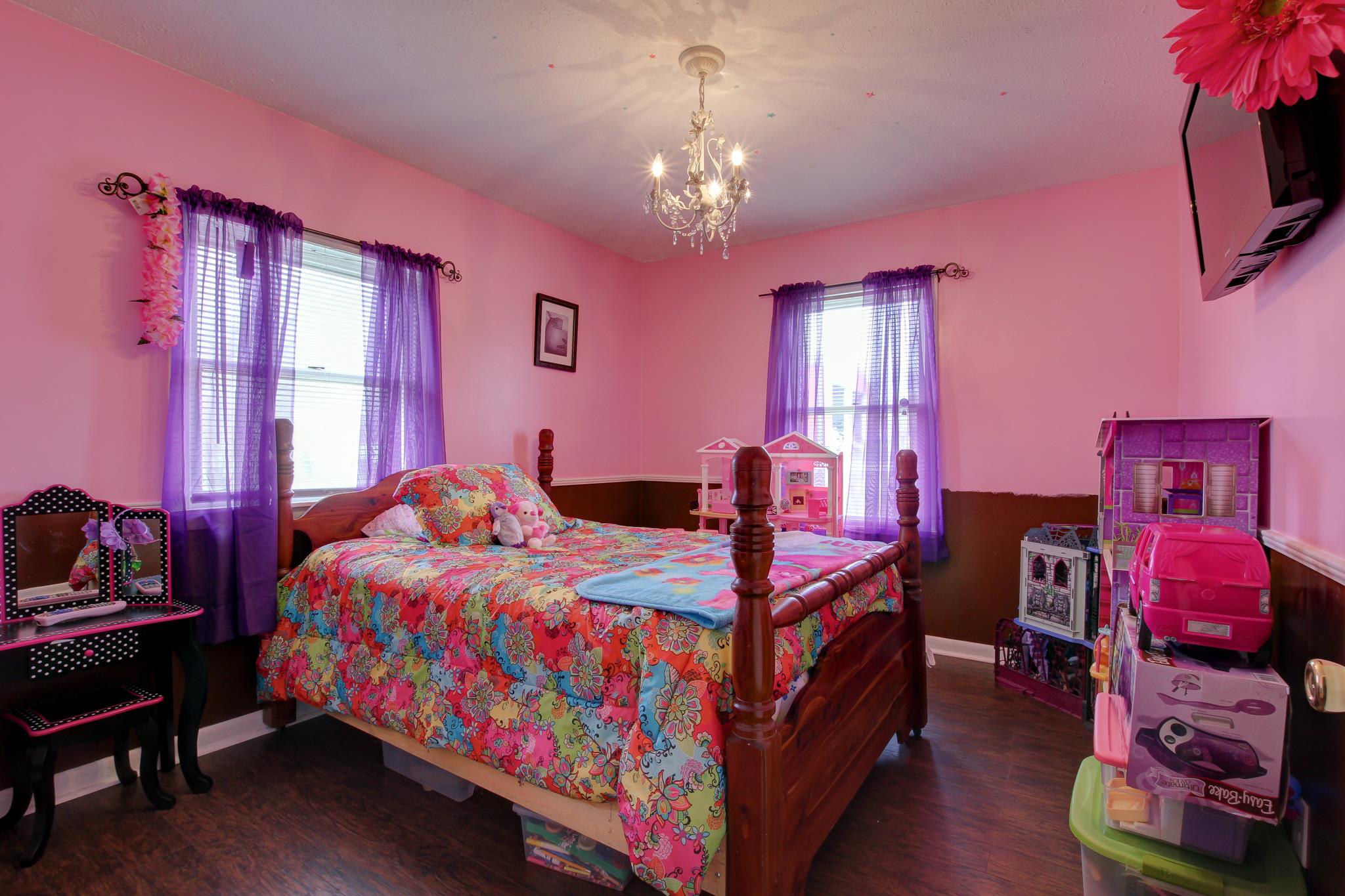 35 Locust Road Erin, TN 37061 - Photo 10 of 20 a bedroom with a bed a chandelier and dresser