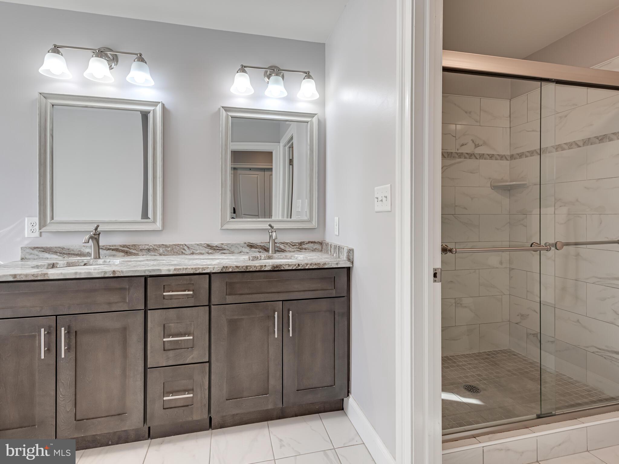 1718 Bethel Road Garnet Valley, PA 19060 - Photo 36 of 58 a bathroom with a granite countertop sink a mirror and a shower
