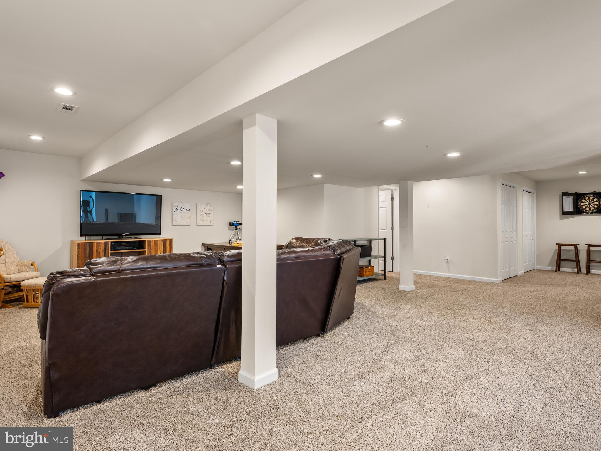 1718 Bethel Road Garnet Valley, PA 19060 - Photo 50 of 58 a living room with stainless steel appliances kitchen island furniture and a flat screen tv