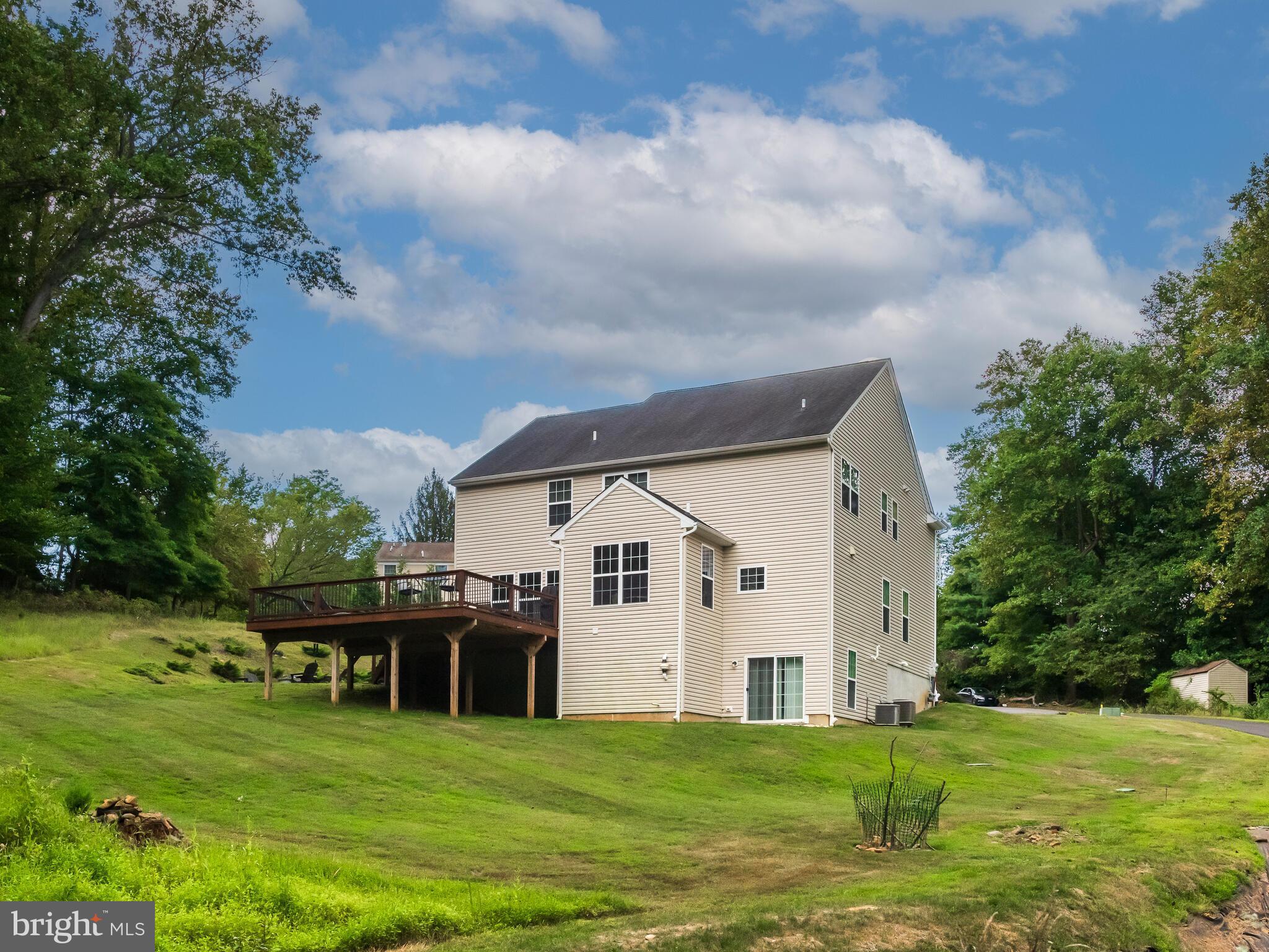 1718 Bethel Road Garnet Valley, PA 19060 - Photo 10 of 58 a white house with a big yard and large trees
