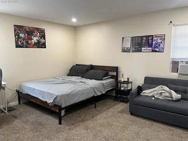 a bedroom with a bed and a couch