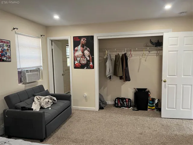 a living room with furniture and a gym