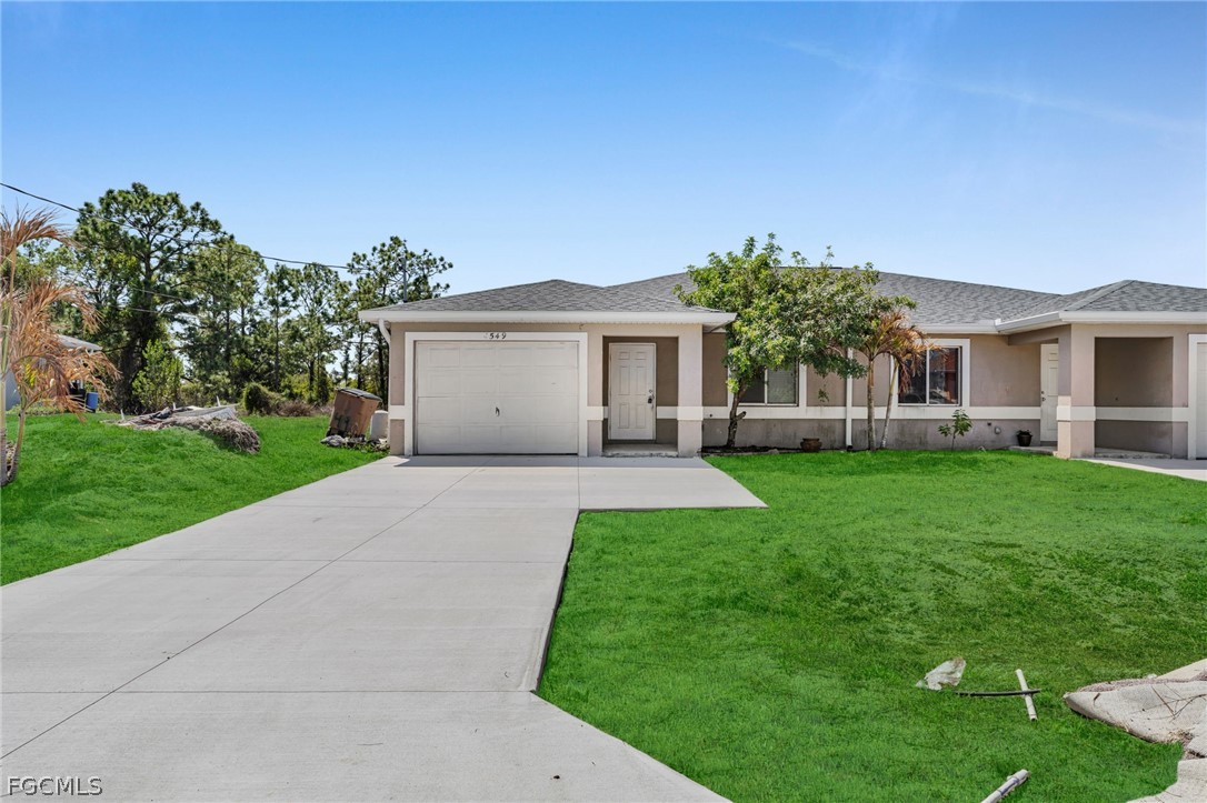 a front view of house with yard and green space