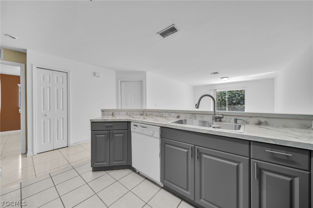 4549 22nd Street Southwest Lehigh Acres, FL 33973 - Photo 12 of 27 a kitchen with a sink and cabinets
