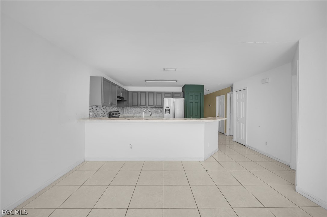 4549 22nd Street Southwest Lehigh Acres, FL 33973 - Photo 14 of 27 a view of kitchen with cabinets and white appliances