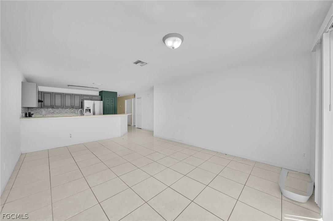 4549 22nd Street Southwest Lehigh Acres, FL 33973 - Photo 15 of 27 a view of a kitchen with white cabinets