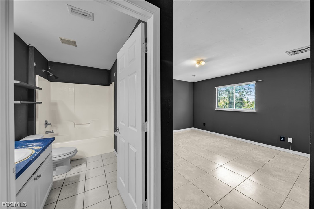 4549 22nd Street Southwest Lehigh Acres, FL 33973 - Photo 17 of 27 a view of a hallway with a bathroom