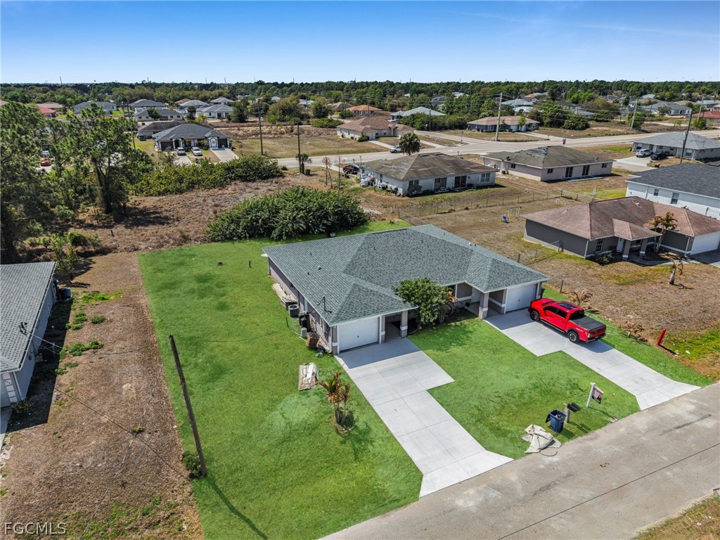 4549 22nd Street Southwest Lehigh Acres, FL 33973 - Photo 22 of 27 an aerial view of a houses with outdoor space