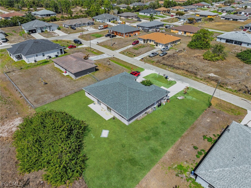 4549 22nd Street Southwest Lehigh Acres, FL 33973 - Photo 24 of 27 an aerial view of residential houses with outdoor space