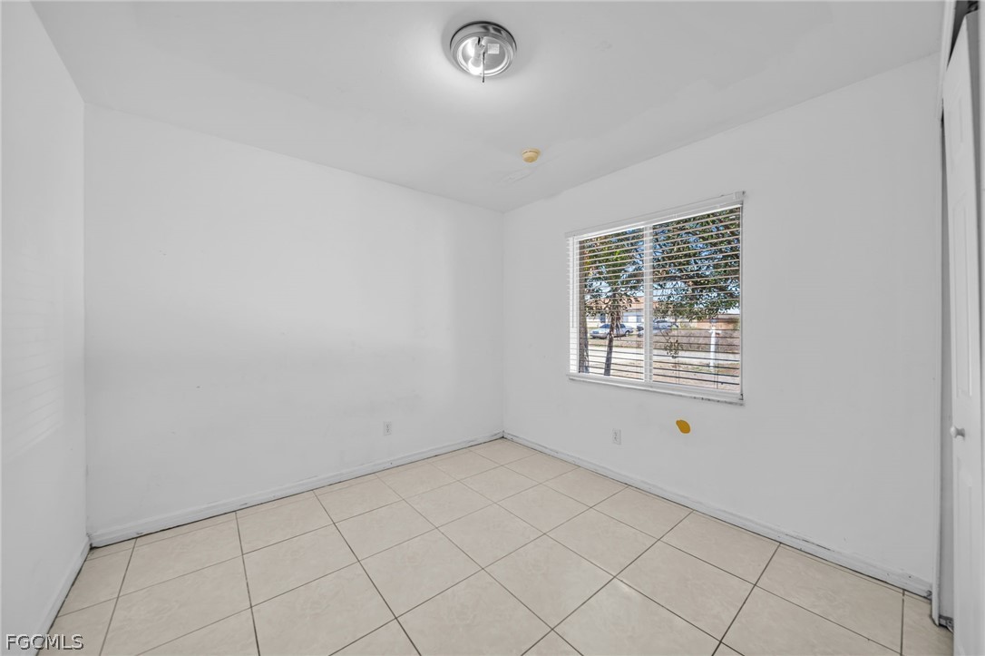 4549 22nd Street Southwest Lehigh Acres, FL 33973 - Photo 5 of 27 an empty room with windows