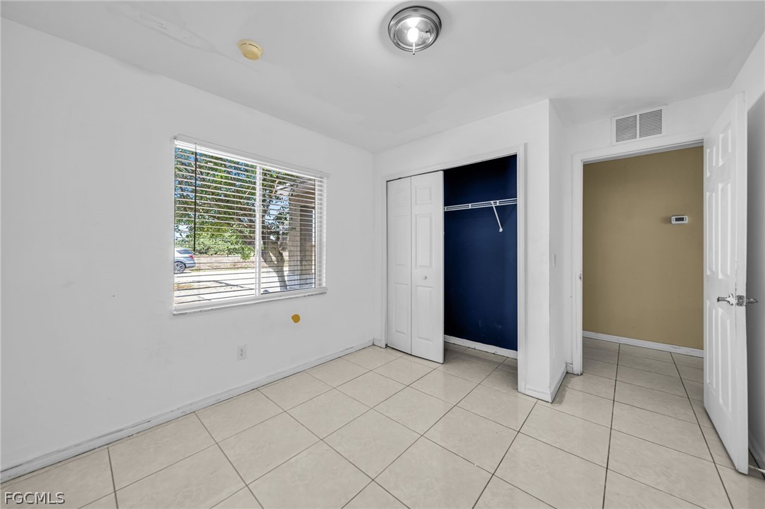 4549 22nd Street Southwest Lehigh Acres, FL 33973 - Photo 6 of 27 an empty room with windows