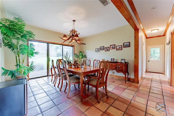a view of a dining room with furniture and a potted plant