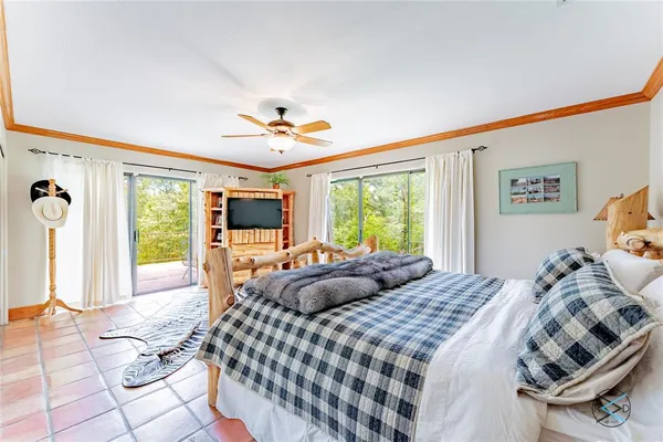 a bedroom with a large bed and a window
