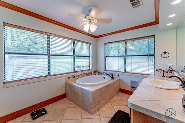 a bath tub sitting in a bathroom next to a window
