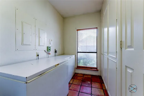 a room with white cabinets and white appliances