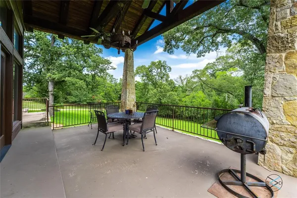 a view of a patio with a table chairs and a yard