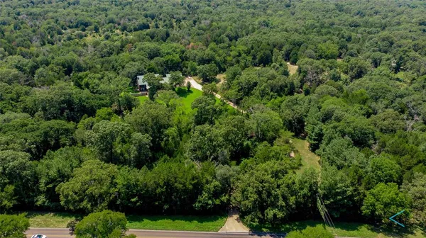 an aerial view of a house with yard