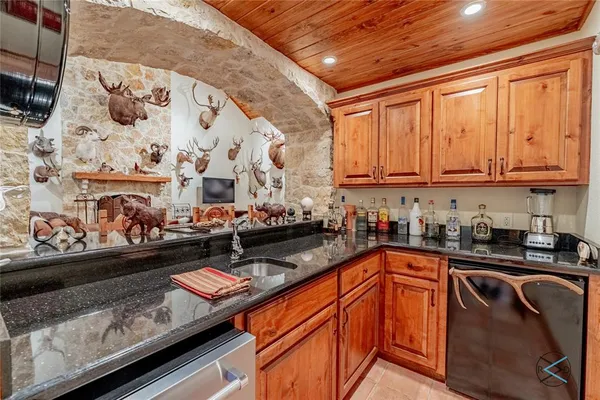 a kitchen with stainless steel appliances granite countertop a sink stove and cabinets