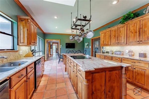 a kitchen with stainless steel appliances granite countertop a sink and a stove