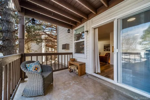 a balcony with furniture and wooden floor