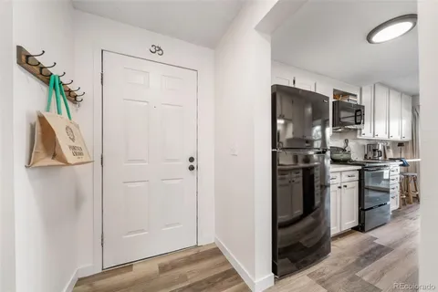 a kitchen with stainless steel appliances white cabinets and a stove top oven