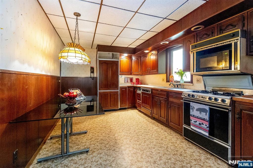 66 Coeyman Avenue Bloomfield, NJ 07003 - Photo 4 of 29 a kitchen with stainless steel appliances granite countertop a stove a sink and a microwave