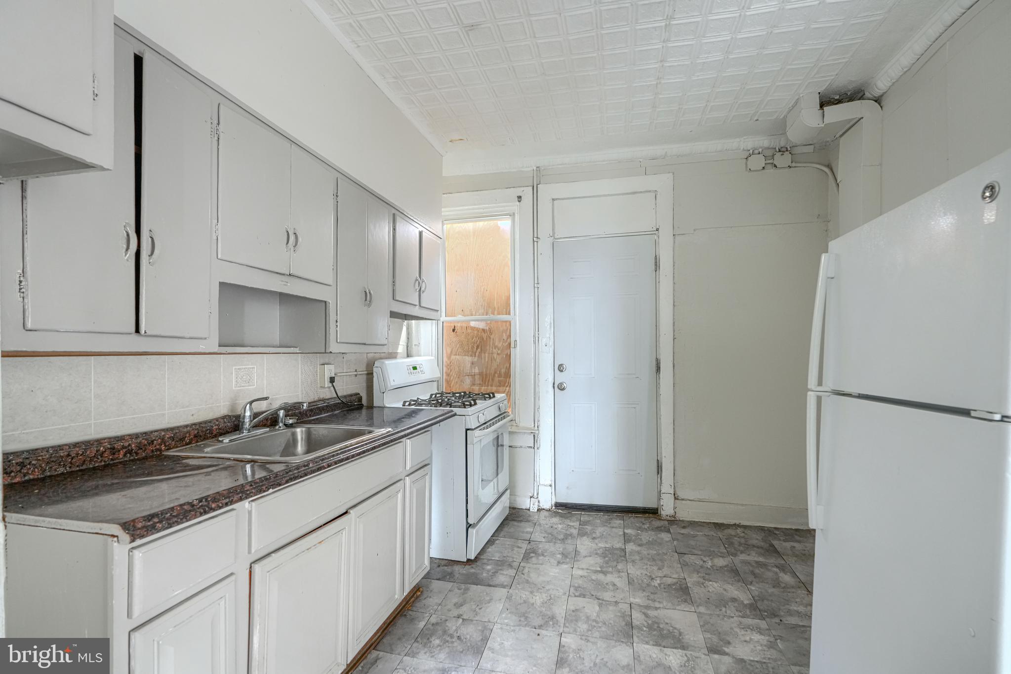 4806 Reisterstown Road Baltimore, MD 21215 - Photo 11 of 34 a kitchen with stainless steel appliances granite countertop a sink stove and refrigerator