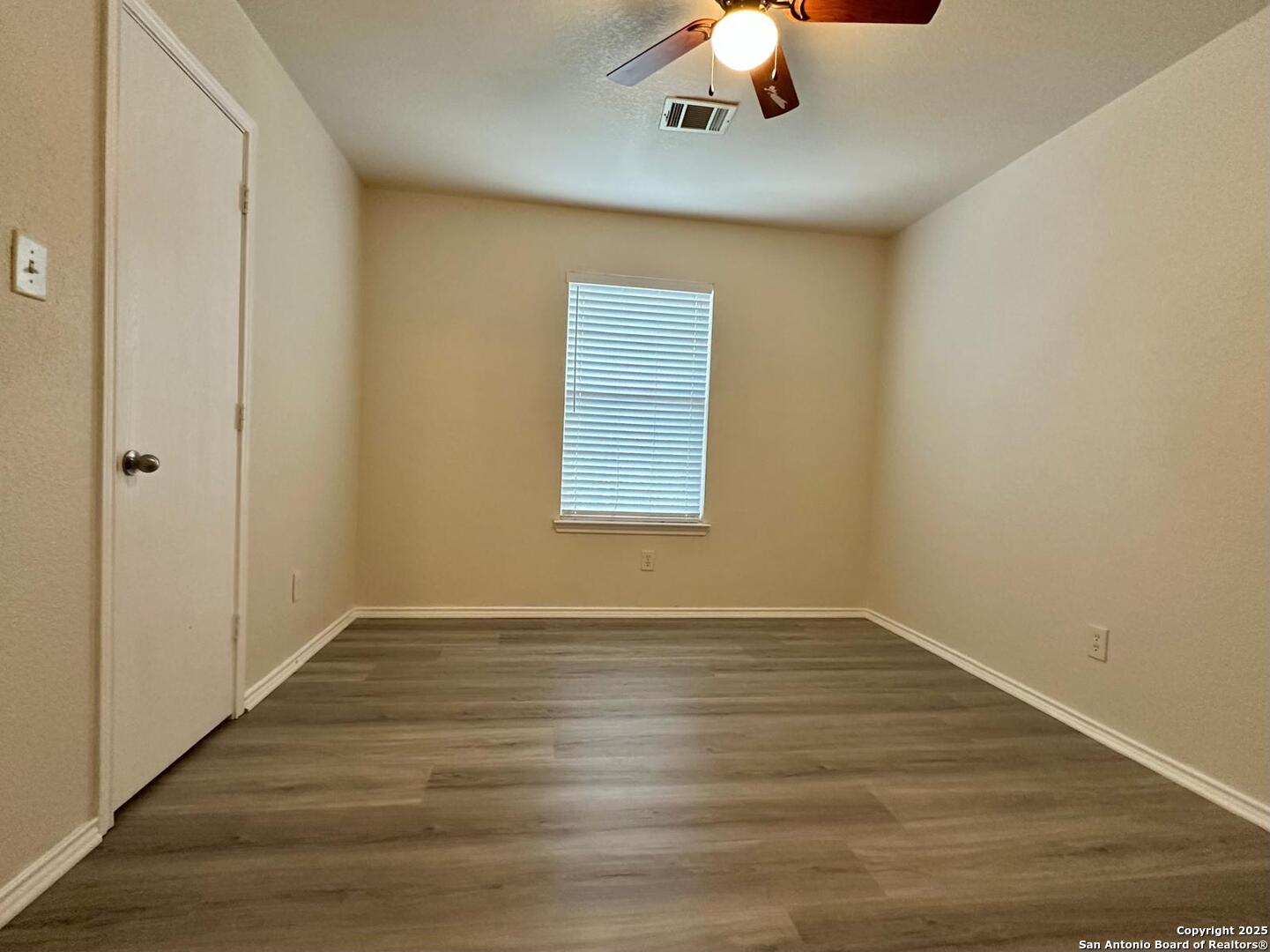 9414 Ingleton San Antonio, TX 78245 - Photo 12 of 17 a view of an empty room with wooden floor and a window