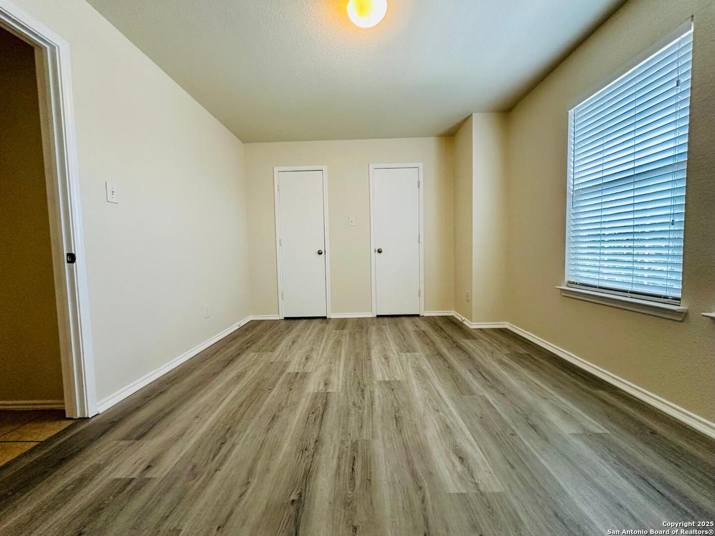 9414 Ingleton San Antonio, TX 78245 - Photo 13 of 17 a view of a room with wooden floor and windows