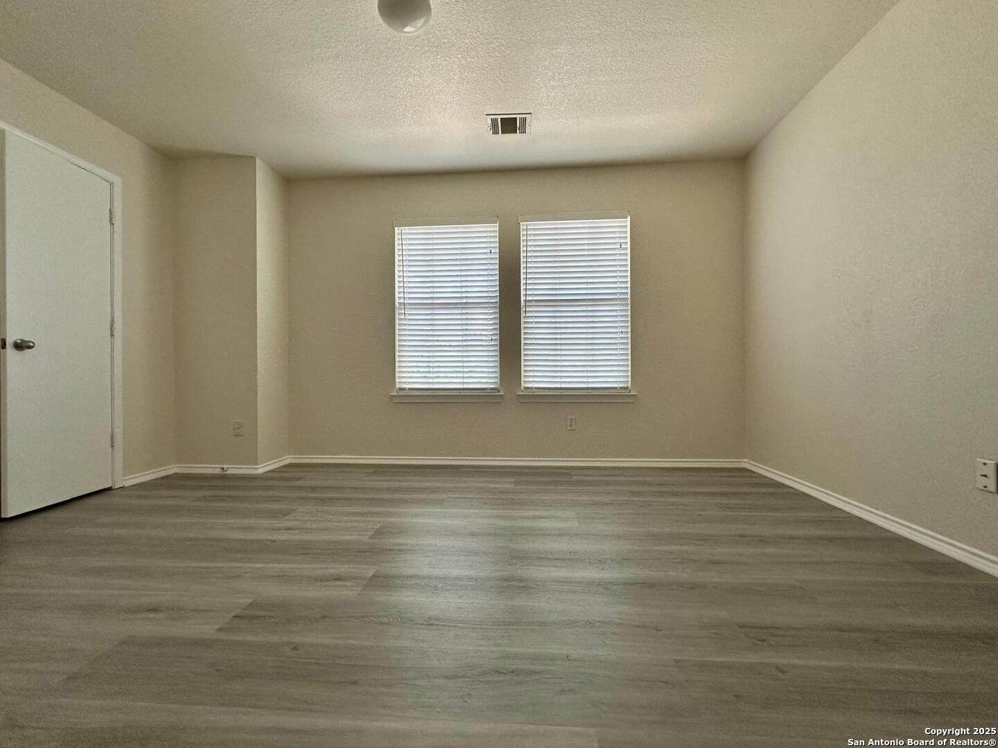9414 Ingleton San Antonio, TX 78245 - Photo 14 of 17 a view of an empty room with wooden floor and a window