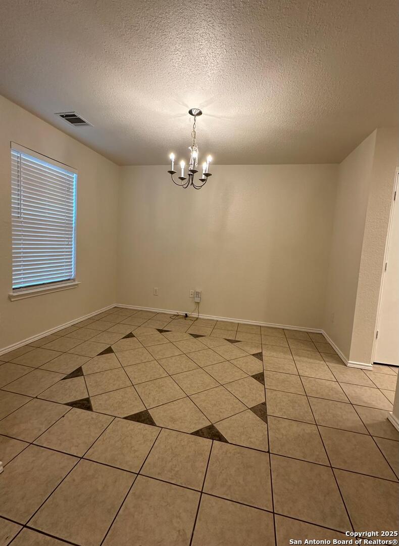 9414 Ingleton San Antonio, TX 78245 - Photo 4 of 17 a view of a room with a chandelier fan and glass windows