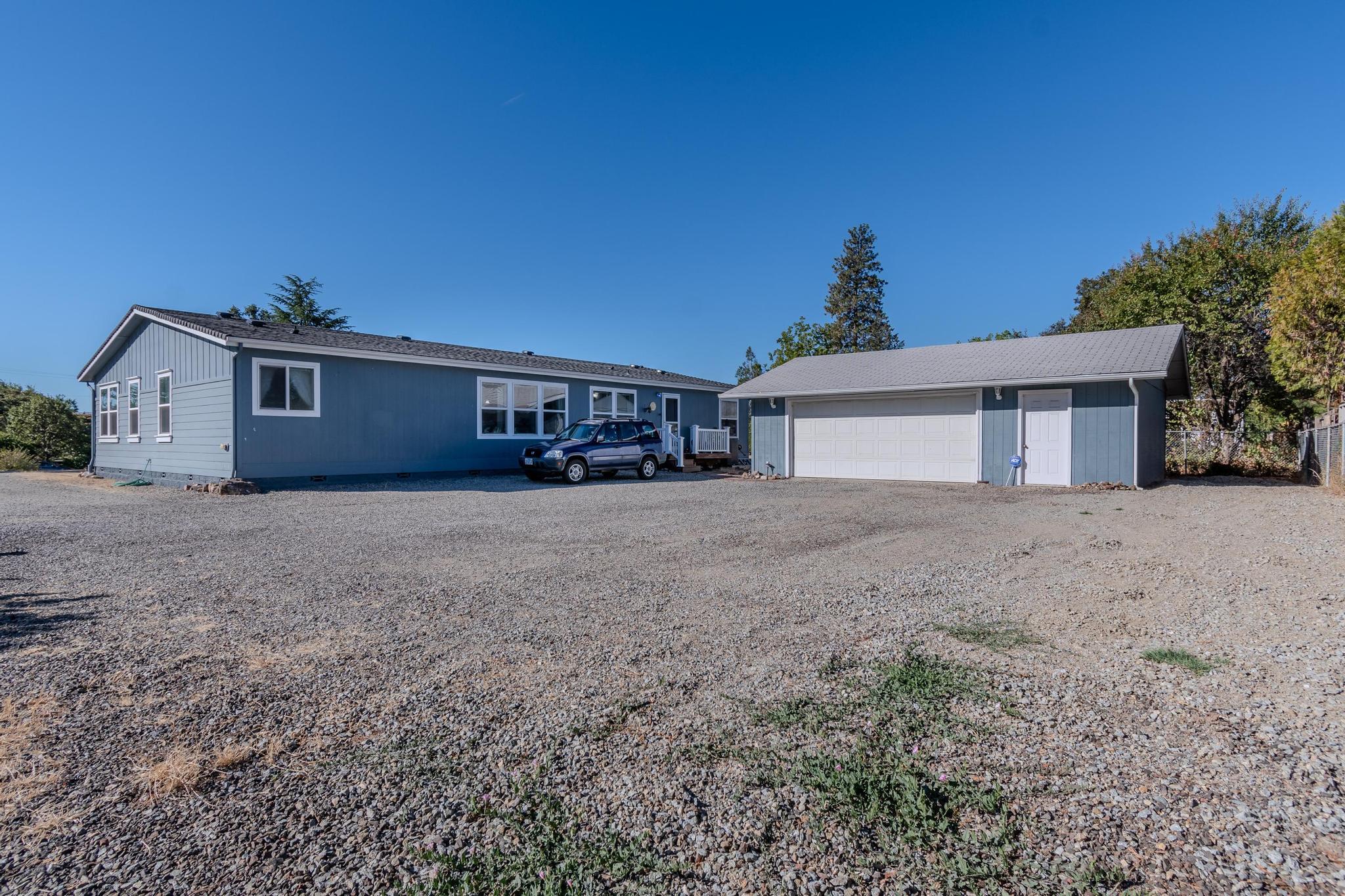 187 East Gregory Road Central Point, OR 97502 - Photo 3 of 29 a front view of a house with a yard