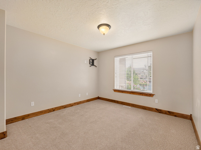 1279 West 1500th Street North Mapleton, UT 84664 - Photo 8 of 83 Neutral-toned walls complement plush carpeting and natural wood trim
