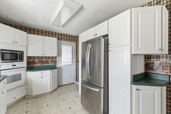 a kitchen with a sink window and cabinets