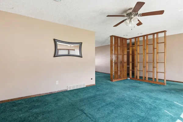 a view of an empty room with floor to ceiling windows
